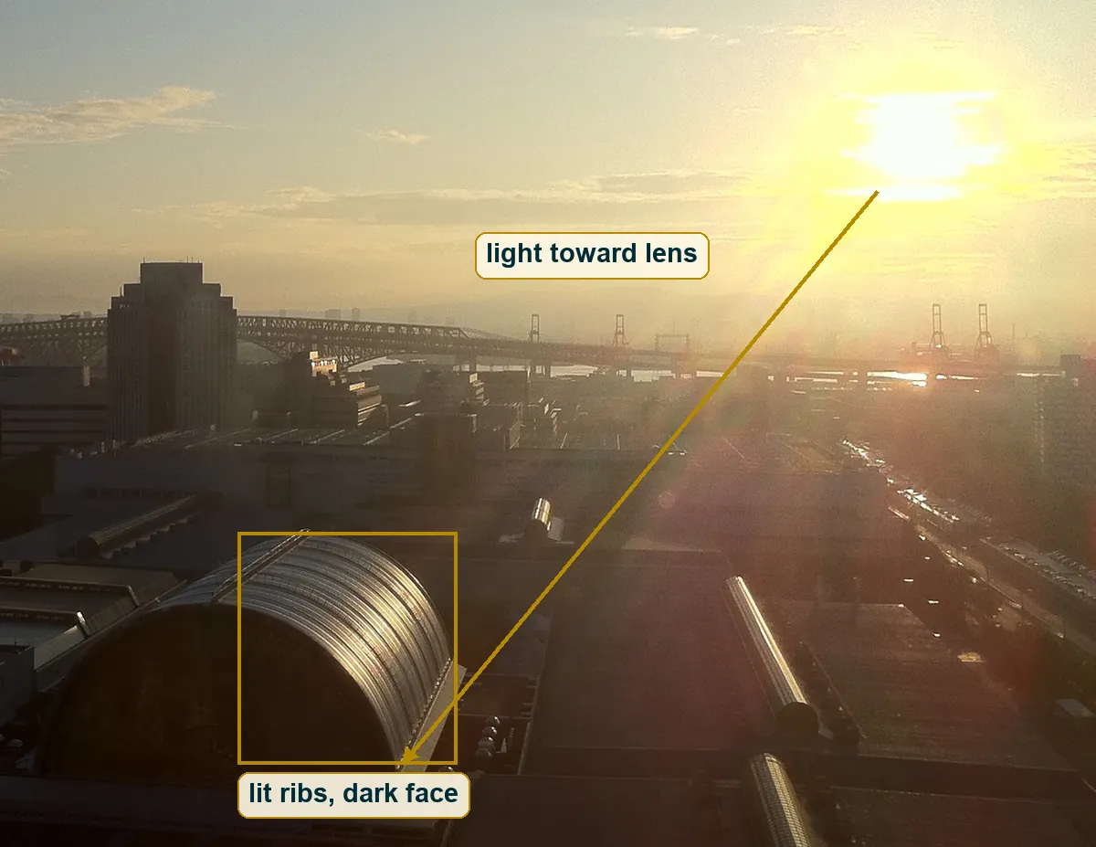 Right half of the frame with an arrow from the sun down toward the camera and the vault roof boxed, ribs lit and end face dark
