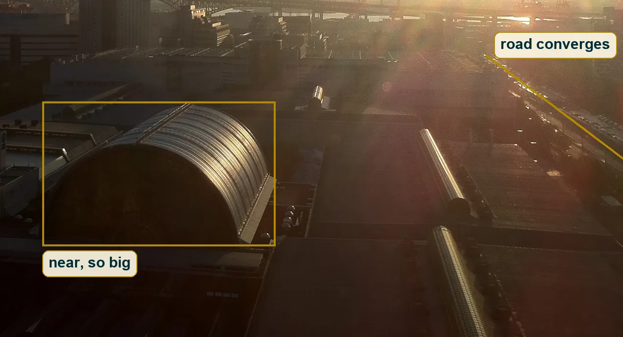 Lower right foreground with the big glass vault and the road lines converging toward the sun