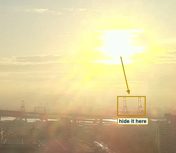 Crop around the sun with the small cranes just below it marked as a place to hide the sun
