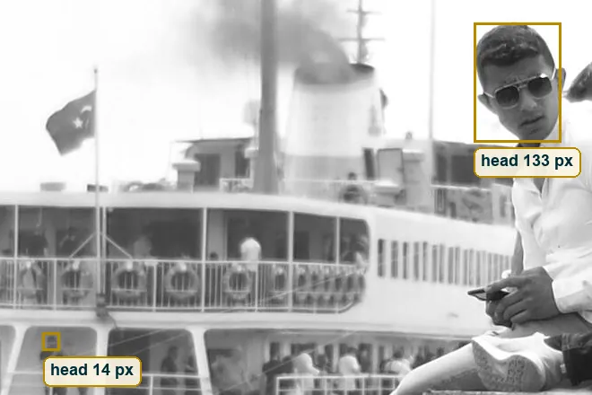 Crop comparing the head size of the man on the wall with a passenger on the ferry