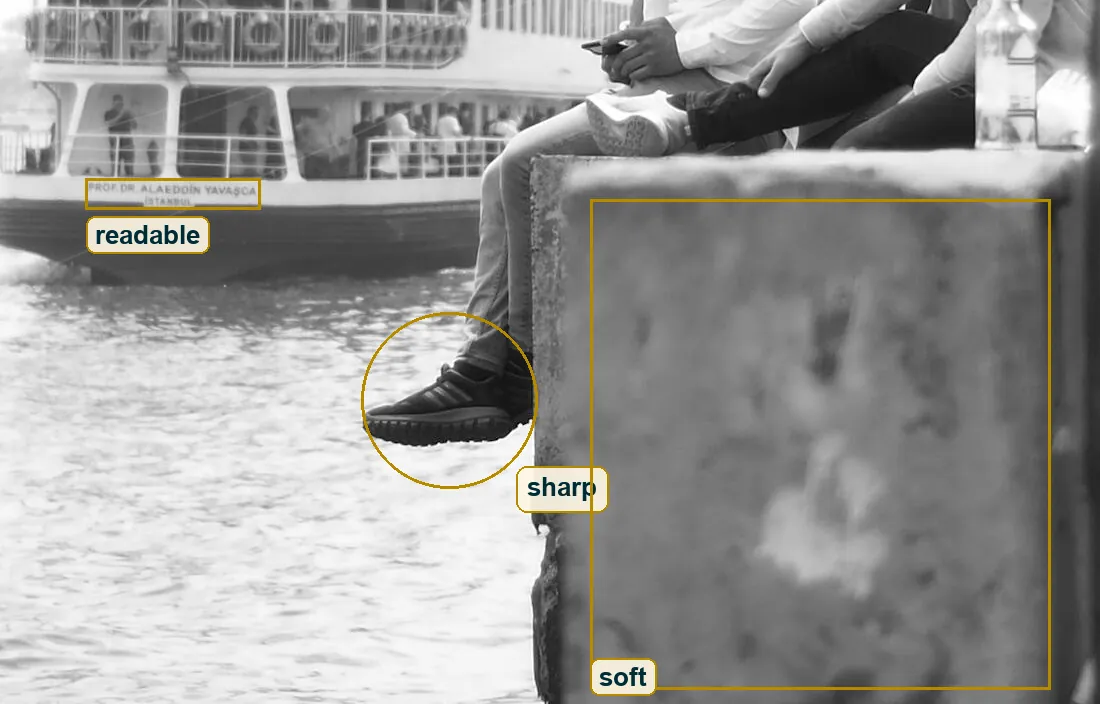 Lower half of the photo with the readable ferry name, the sharp sneakers and the soft near wall marked