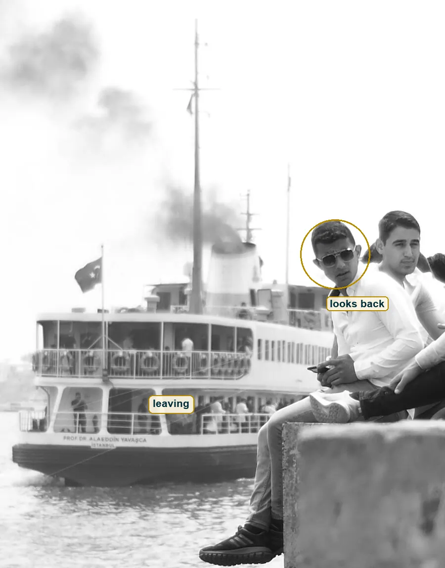 Crop of the leaving ferry with its smoke and the man in aviators looking back