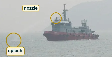 Crop of the water jet leaving the ship's roof and falling into the sea ahead of the bow