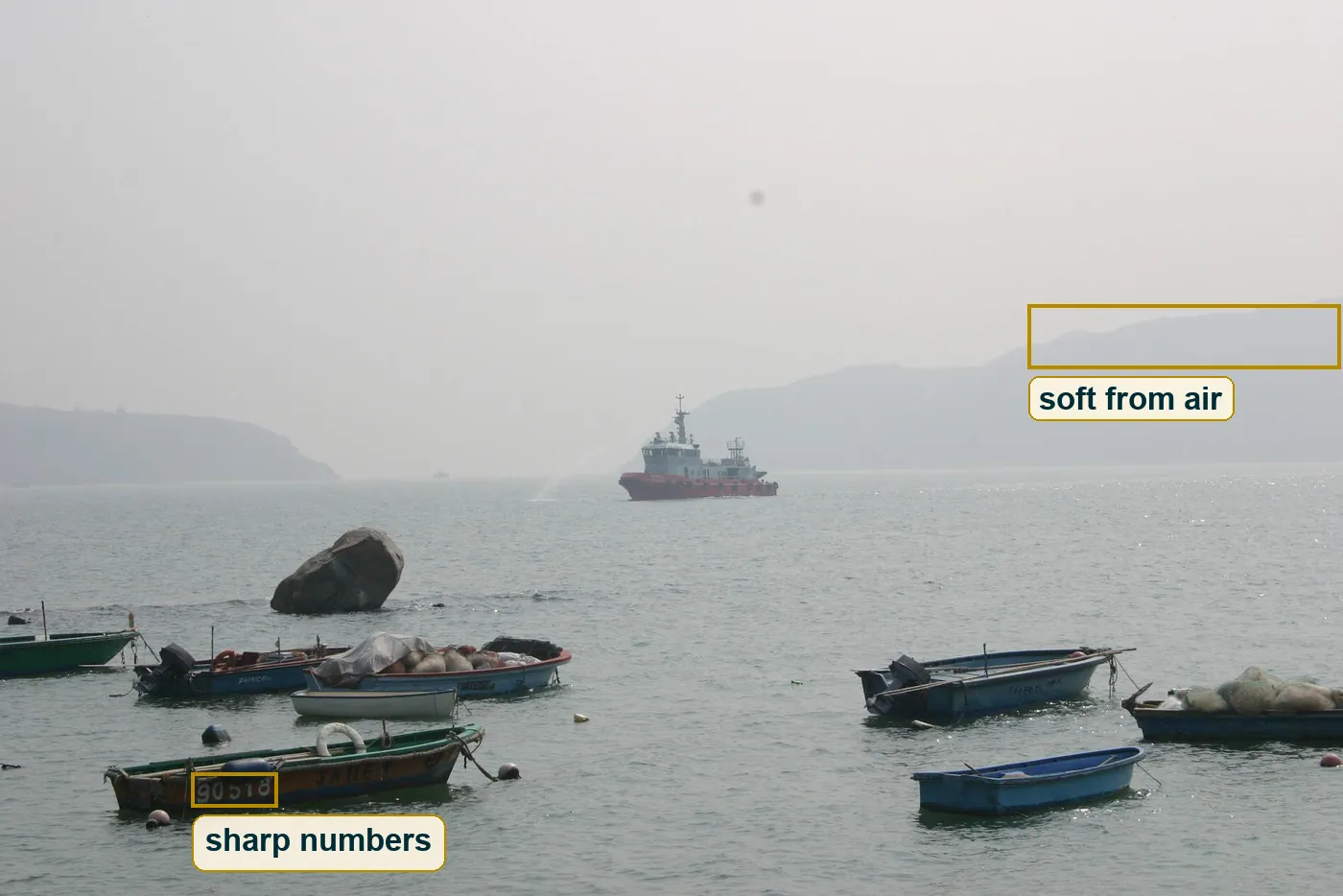 Full photo with boxes on the sharp painted boat number and the soft far ridge