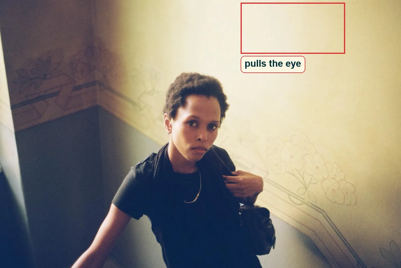 Full photo with the bright wall above her head marked in red
