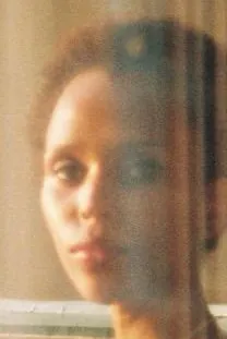 Tight crop of her face behind the glass